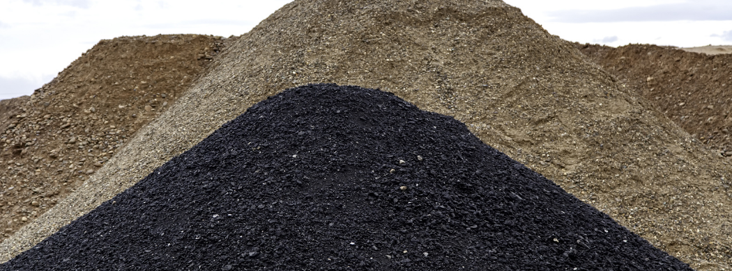 Image of mounds of soil and stone ready for recycling at Nolan Recycling.